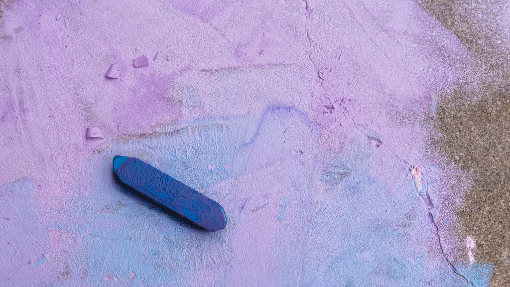 side walk covered in purple chalk 