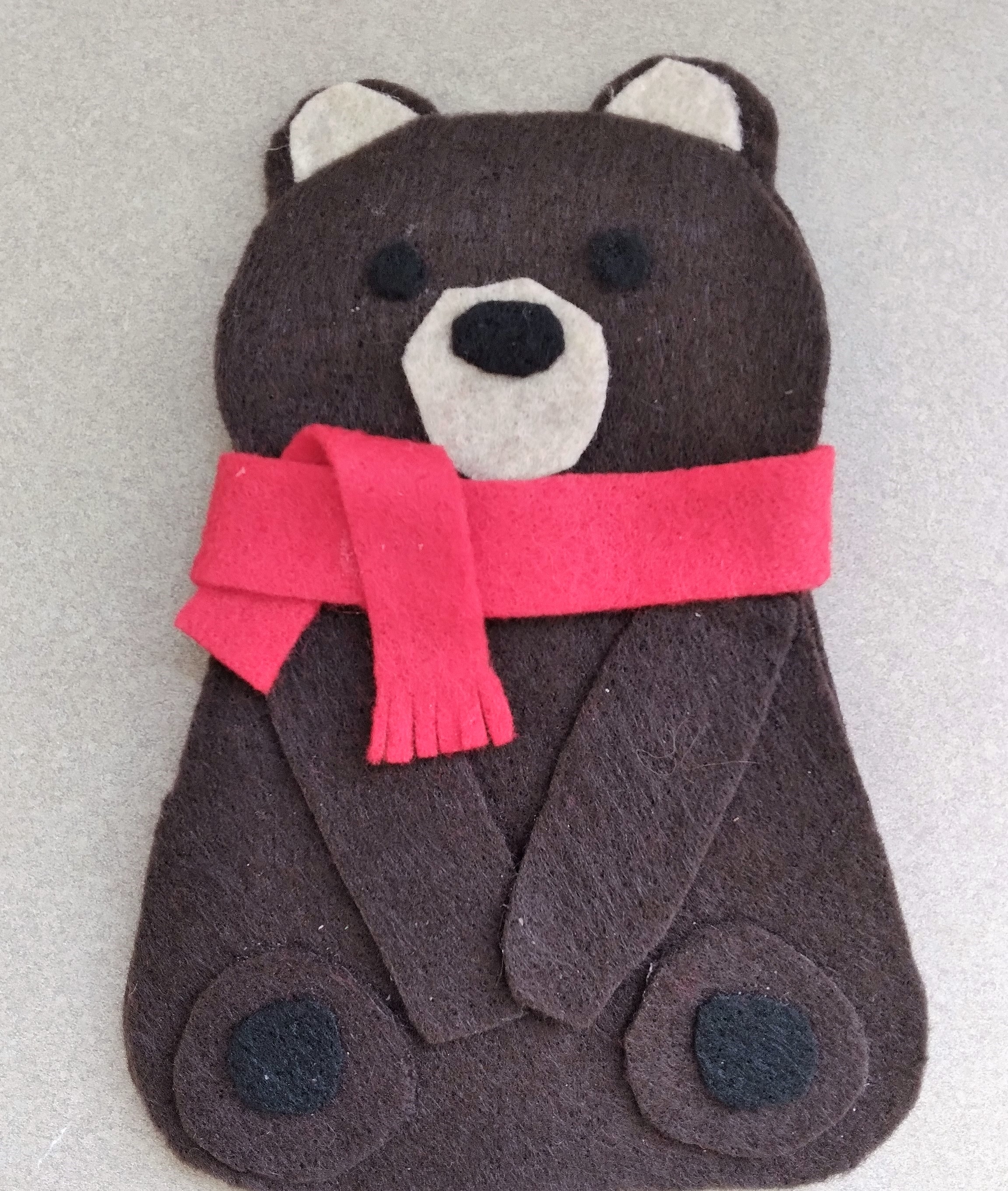 brown felt bear with red scarf