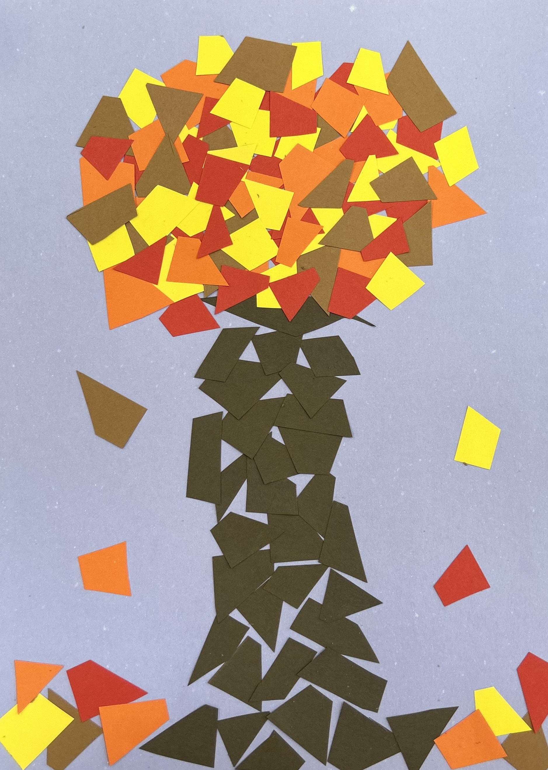 A fall tree made out of small pieces of cut construction paper