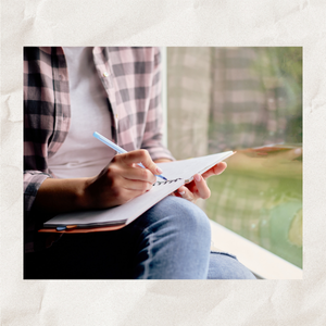 Woman writing in notebook.