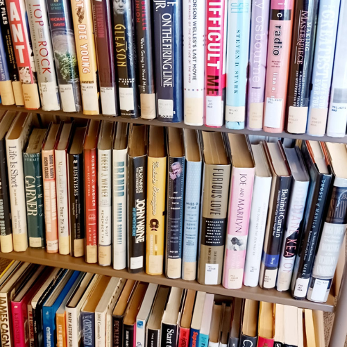 3 tiered cart filled with hardcover books. 